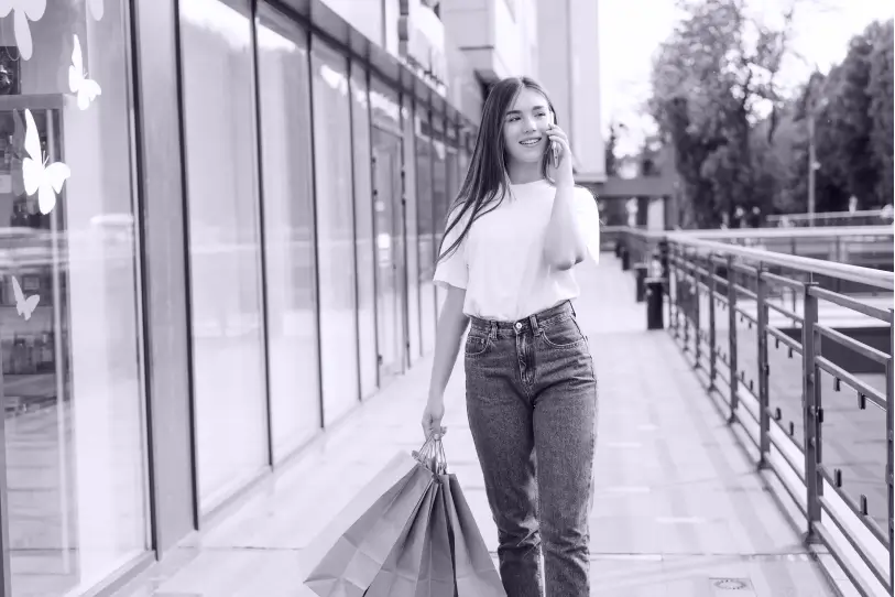 beautiful-shopping-woman-talking-her-cell-phone-walking-with-bags-street